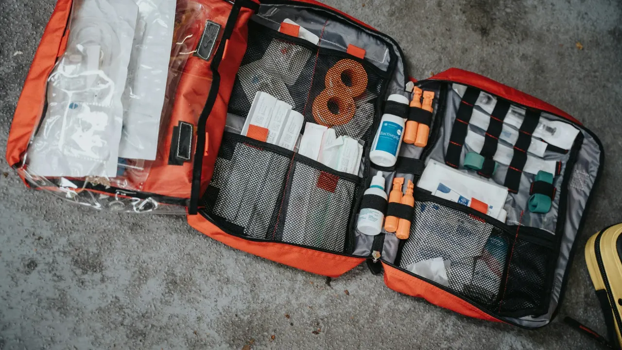 An open first-aid bag with supplies separated into compartments
